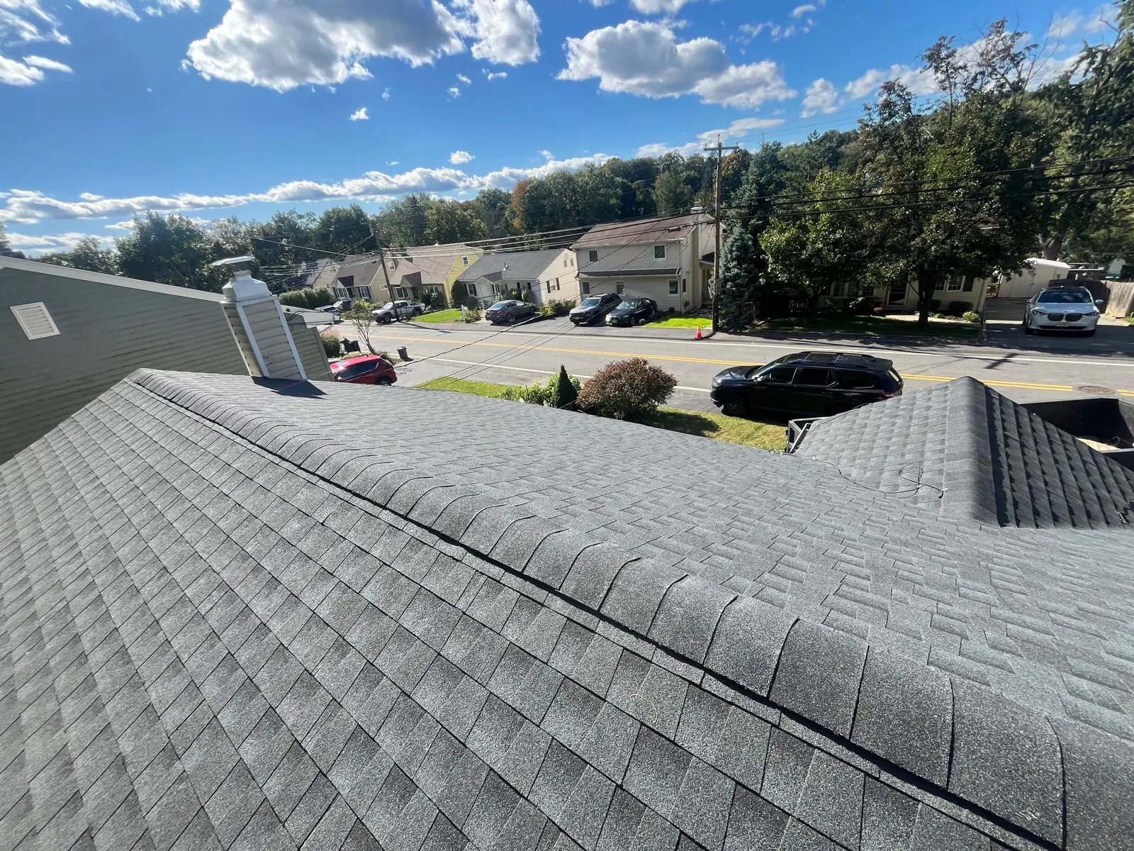 Completed roof with new grey shingles and ridge vent