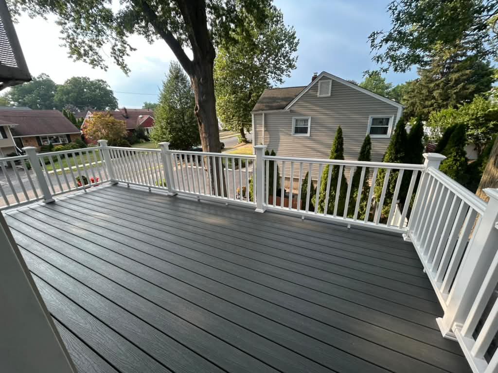 Finished grey deck with white railings after installation