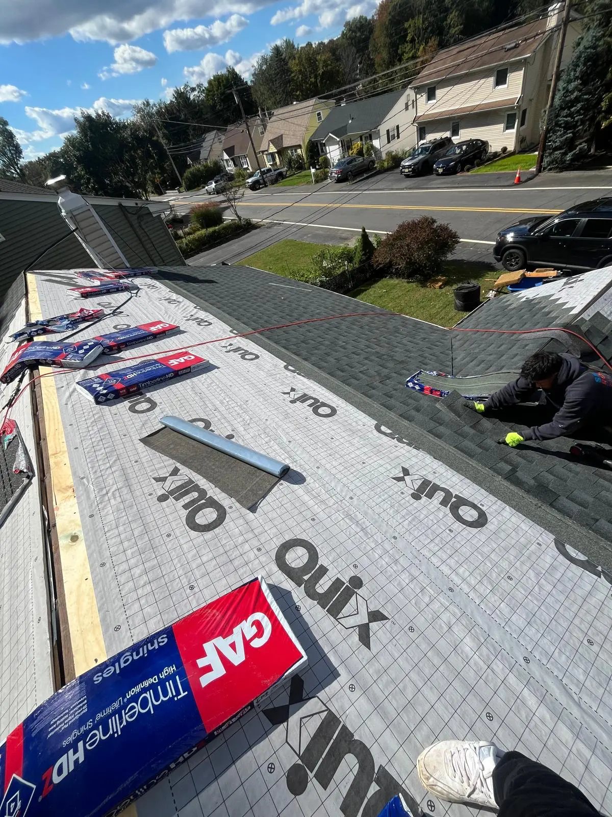 Underlayment installed with new shingles being laid on the roof