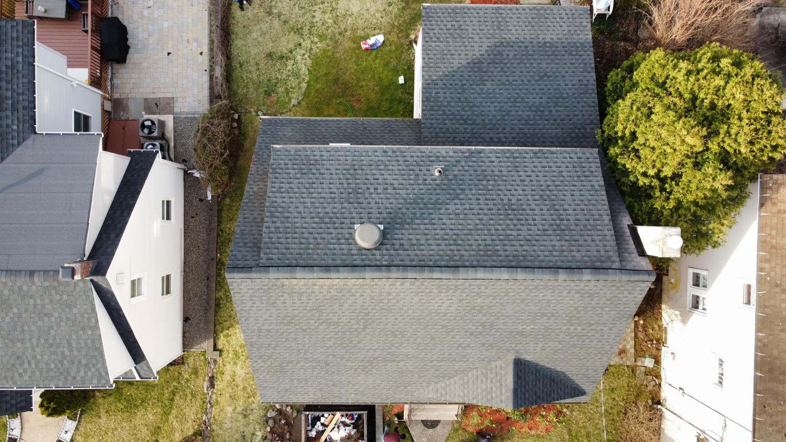 Aerial view of the completed shingle roof after replacement