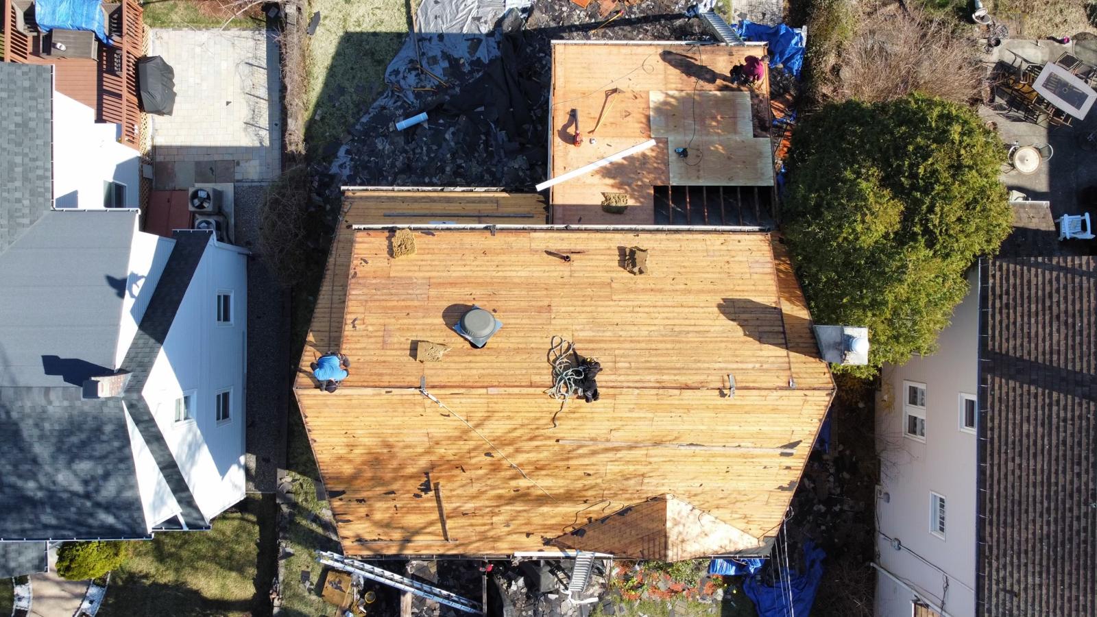 Aerial view of the roof stripped to bare decking during replacement work
